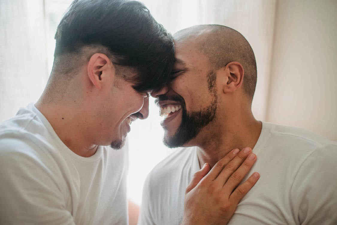 A laughing couple leaning into each other